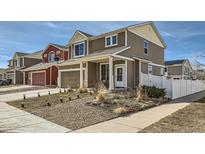 Charming two-story home featuring neutral siding, a well-manicured lawn, and a welcoming covered porch at 5541 Killarney Ct, Denver, CO 80249