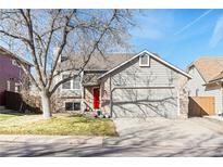 Charming two-story home with a two-car garage and a well-manicured lawn in a suburban neighborhood at 9905 Foxhill Cir, Highlands Ranch, CO 80129