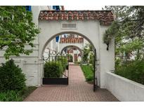 Inviting gated brick walkway with arched entryway and lush landscaping welcomes you home at 844 N Humboldt St # 5, Denver, CO 80218