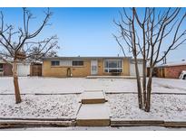 Charming one-story home featuring brick exterior and snow-covered front yard at 3108 Quari St, Aurora, CO 80011