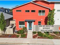 Attractive modern home with a vibrant orange exterior, landscaped yard, and a welcoming entrance at 2004 Foxtail Ln # B, Lafayette, CO 80026