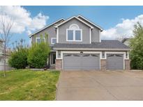 Charming two-story home with a three-car garage and well-maintained lawn in a suburban neighborhood at 6227 Shenandoah Ave, Firestone, CO 80504