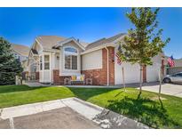 Charming home with a well-manicured lawn and a cozy front porch with decorative elements at 3104 Newport Cir, Castle Rock, CO 80104