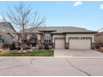 Charming single-Gathering home with a three-car garage, well-maintained lawn, and welcoming front porch at 8501 Hackamore Rd, Littleton, CO 80125