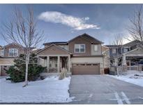 Two-story house with a large front yard, driveway, and attached garage at 15726 E Otero Cir, Centennial, CO 80112