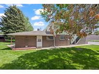 Back exterior of brick home with greenery and stairs to the second story at 3631 W 79Th Ave # A2, Westminster, CO 80030