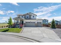 Charming two-story home with a three-car garage and a well-manicured lawn at 918 Honey Berry Ct, Elizabeth, CO 80107