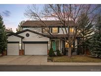 Charming two-story home featuring a well-maintained front yard and an attached two-car garage at 1808 Southard St, Erie, CO 80516