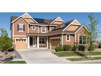 Charming two-story home featuring a two-car garage, well-maintained lawn, and solar panels for energy efficiency at 14537 Honolulu Cir, Parker, CO 80134