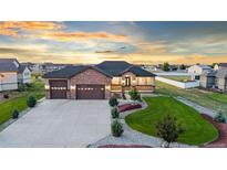Charming single-Gathering home featuring a three-car garage and beautiful stone accents at 29303 E 165Th Ave, Brighton, CO 80603