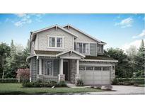 Charming two-story home featuring stone accents, stylish garage door and well-manicured lawn at 12656 W Frost Ave, Littleton, CO 80127