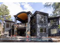 Luxury home featuring a pool, outdoor kitchen and extensive balconies with stunning architectural details at 1070 Cypress Way, Castle Rock, CO 80108