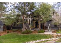 Unique modern home with slate facade, rock landscaping and mature trees creating curb appeal at 1070 Cypress Way, Castle Rock, CO 80108