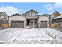 Beautiful two-story home featuring a three-car garage and gray stone accents at 2598 Knobbie Cir, Castle Rock, CO 80109