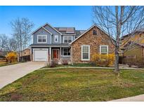 Charming two-story home boasts stone accents, solar panels, and a well-manicured front yard at 13686 Dexter St, Thornton, CO 80602