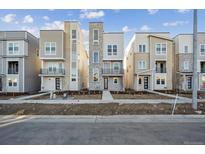 Modern three-story townhomes with attached garages and balconies at 5245 Queen Ct, Arvada, CO 80002