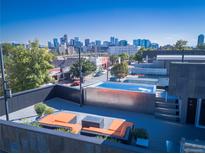 Relax on this rooftop deck with a pool and seating area with views of the city skyline at 3453 Navajo St, Denver, CO 80211