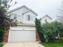 Charming two-story home with a well-maintained lawn and attached two-car garage at 10154 Fairgate Way, Highlands Ranch, CO 80126