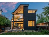 Contemporary home boasting a unique architectural design with expansive windows and a lush green lawn at 360 S Ogden St, Denver, CO 80209