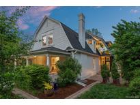 Charming two-story home featuring a gabled roof, a covered front porch, and mature landscaping at 360 S Ogden St, Denver, CO 80209