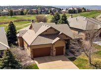 Stunning exterior view of a home featuring a well-manicured lawn, a two-car garage, and a beautiful roof at 6772 Vista Lodge Loop, Castle Pines, CO 80108