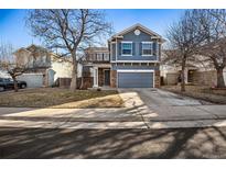 Charming two-story home featuring a well-maintained front yard and a two car attached garage at 19658 E Vassar Dr, Aurora, CO 80013