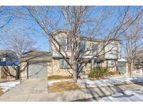 Two-story house with stone accents and a gray garage door at 10219 Vine Ct, Thornton, CO 80229