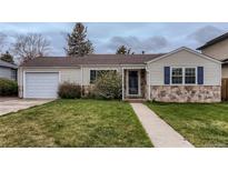 Charming single-story home with stone accents, well-maintained lawn, and attached one car garage in established neighborhood at 2965 S Birch St, Denver, CO 80222