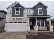 Charming two-story home featuring stone accents, attached two-car garage, and covered front porch at 7291 Prairie Sage Pl, Littleton, CO 80125