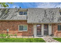 Charming townhome featuring a brick facade, complemented by well-maintained landscaping and a welcoming entrance at 15139 E Wesley Ave, Aurora, CO 80014
