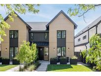 Charming two-story brick home with black trim and a well-manicured front yard at 3932 Kalamath St, Denver, CO 80211