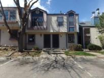 Traditional two-story townhome featuring black door and neutral siding, showcasing classic charm at 453 S Kittredge St # D, Aurora, CO 80017