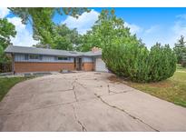 Charming single-story home featuring a brick and siding facade with a spacious driveway and mature landscaping at 3273 S Florence Ct, Denver, CO 80231