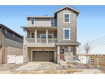 Charming home with two-car garage, second-story balcony, stone accents, and professional landscaping at 2080 S Haleyville Way, Aurora, CO 80018