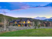 Stunning exterior view of a modern home with mountain views and well manicured lawn at 294 Gold Run Rd, Breckenridge, CO 80424