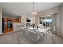 Inviting dining area adjacent to the kitchen, with sliding glass doors to the patio for seamless indoor-outdoor living at 74 Whitehaven Cir, Highlands Ranch, CO 80129