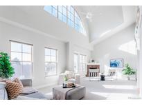 Bright living room features vaulted ceilings, large windows and modern furnishings at 1699 N Downing St # 409, Denver, CO 80218