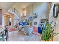 Bright living room features a fireplace, high ceilings, large windows and elegant decor at 2347 S Loveland St, Lakewood, CO 80228