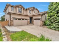 Beautiful two-story home featuring a three-car garage, and neutral toned facade at 10695 Wynspire Rd, Highlands Ranch, CO 80130