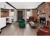 Inviting living room with brick accent wall, fireplace, and modern decor at 3731 N Race St, Denver, CO 80205