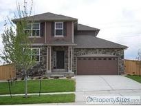 Two story home with a stone and vinyl exterior and a two car garage at 4764 S Duquesne St, Aurora, CO 80016