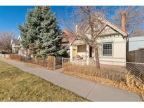 Charming single-Gathering home featuring unique architectural details, a front porch, and well-maintained landscaping at 3135 California St, Denver, CO 80205