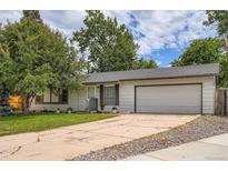 Charming single story home featuring an attached two car garage and mature landscaping at 3358 S Iris Ct, Lakewood, CO 80227