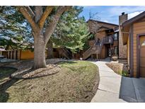 Condominium exterior features private entrance, mature trees, and landscaping at 6148 Willow Ln, Boulder, CO 80301