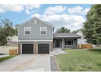 Charming two-story home with a well-manicured lawn and a two-car garage at 7123 S Hudson Cir, Centennial, CO 80122