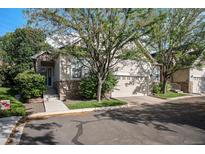 Charming home featuring stone accents, a well-maintained yard, and a two-car garage at 6626 S Reed Way # A, Littleton, CO 80123