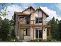 Charming two-story home featuring a stone facade, balcony, and a welcoming green front lawn at 3864 W 82Nd Ln, Westminster, CO 80031
