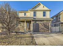 Inviting two-story home with stone accents, neutral siding, and an attached two-car garage at 18241 E 47Th Dr, Denver, CO 80249