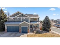 Charming two-story home with well-maintained landscaping, three car garage, and inviting front porch at 1929 Baguette Dr, Castle Rock, CO 80108