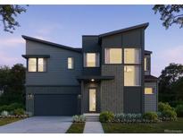 Modern two-story home with dark siding, brick accents, and a two-car garage at 11499 Alla Breve Cir, Lone Tree, CO 80134